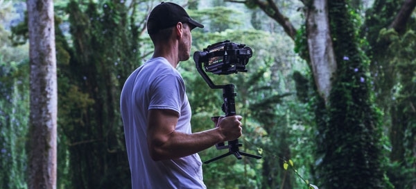 man-in-white-shirt-holding-camera